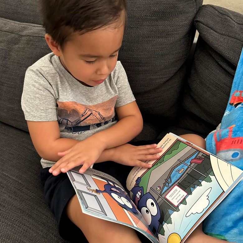 Toddler reading Safe Splash Spectacular